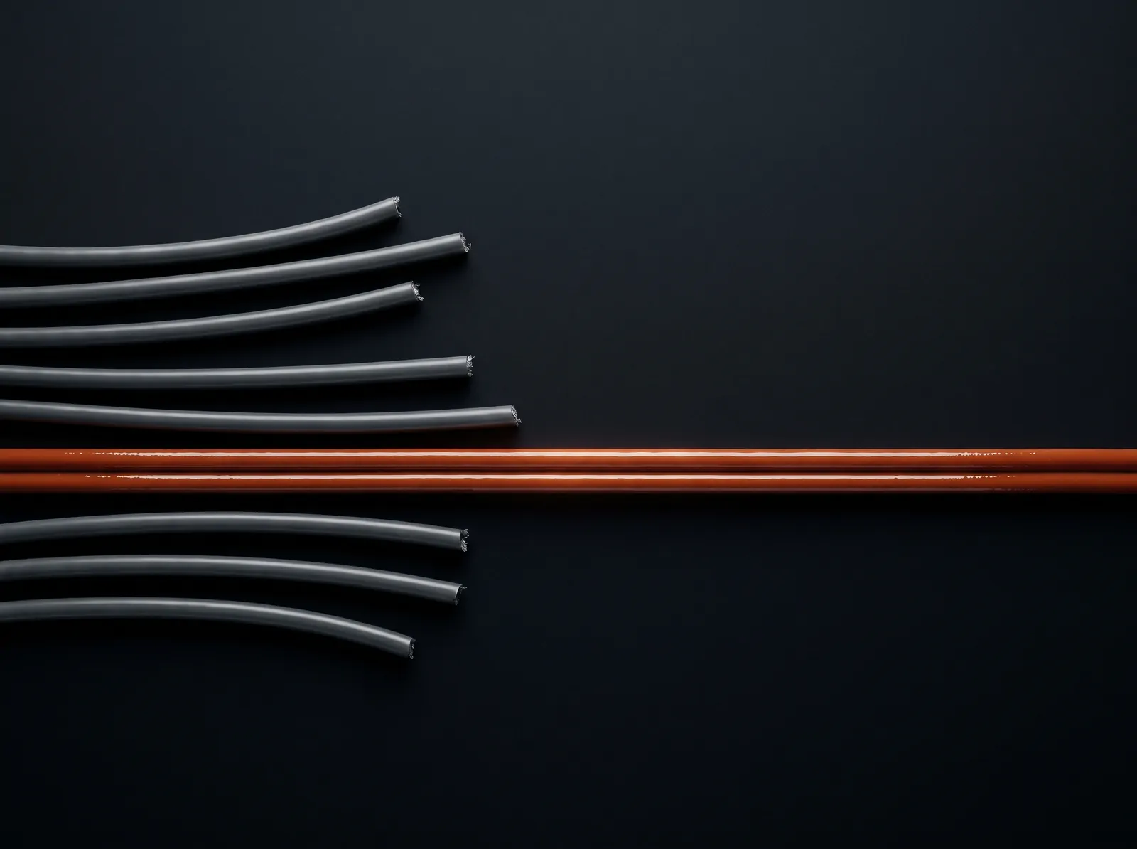 Seen from above: seven cords enter from the left, six stop short and go grey, one orange cord runs straight on to the right edge.